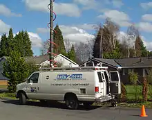 A white panel van with a microwave attachment on top and KATU logos on the side