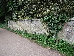 Millstones in garden wall near the site of Coombe Mill.  Picture credit: Know Your Place web site.