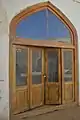 A wooden door that leads to the mausoleum of the martyrs who were killed in the Iranian Revolution