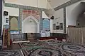 Inside the mosque, one of the prayer halls, with a mihrab visible.