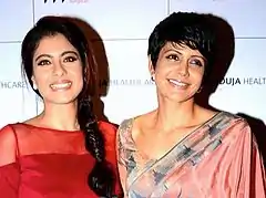 Kajol and Mandira Bedi smile at the camera.