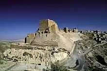 A castle built of stones on a cliff near a settlements