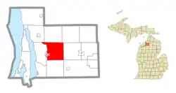 Location within Antrim County (red) and an administered portion of the Bellaire village (pink)