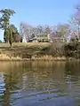 King of All Places manor house as seen from Cypress Creek