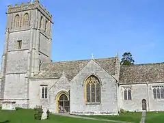 Stone building with square tower.