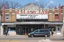 Front of two storey building decorated with lights and large sign saying Kingsway