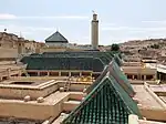 Rooftop view of the Kissaria in 2023, after recent renovations, with sloped wooden roofs covered in green tiles