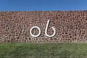 The Kokernot Ranch "06" brand on a rock wall at Kokernot Field.