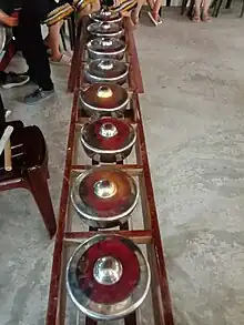 Eight small silver gong-chimes arranged facing up.