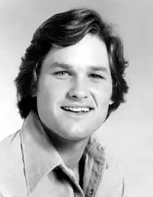 Black and white photo of a young man looking into the camera