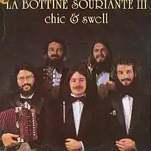 Photograph of La Bottine Souriante, posing with instruments