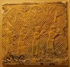 Photograph of a scene from Lachish Relief: Judahites from Lachish in Assyrian captivity, playing a later form of the Egyptian lyre