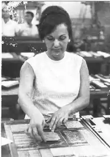 A woman artist at work at a table