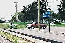 A small railway platform next to a single track