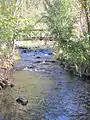 Footbridge over Great Hollow Lake babbling brook