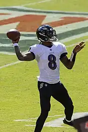 Jackson throwing a football on the field