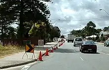 Cone taper for left lane closure in Western Australia showing small chevron (shifter), 40 km/h repeater, chevron and arrow-board