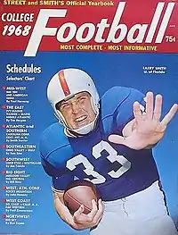 Color rendering of 1968 cover of Street & Smith magazine, showing a close-up of football player Larry Smith in the royal blue, white and orange uniform of the Florida Gators, carrying a football in one hand with the other outstretched toward the camera.