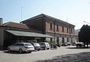 Brick-and-stucco two-story building with gabled roof