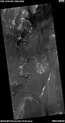 Wide view of layers in a crater and light-toned material, as seen by HiRISE under HiWish program.  Light-toned materials often contain water bearing minerals like sulfates.