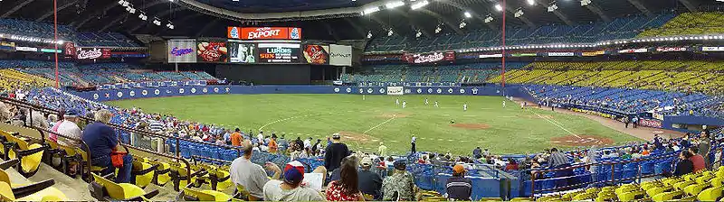 A sparse crowd watches during pre-game warmups.