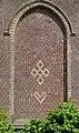 Rune-shaped designs (five-lozenges cross and heart) on the gable of Ledringhem's church