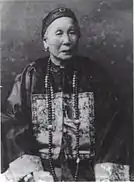 Photograph of elderly Chinese woman in Qing dynasty fashion