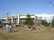 Old-looking football stadium in empty field