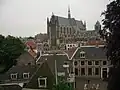 View towards the Southeast from the top of the steps, showing the Hooglandse Kerk in the distance, and the back of the wrought iron gate and the Herenlogement in the foreground.