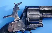 A close-up of the hammer on a LeMat Pinfire Revolver shows the pivoting striker that could be used to fire the pinfire cartridges in the revolving chambers or the secondary smoothbore barrel.