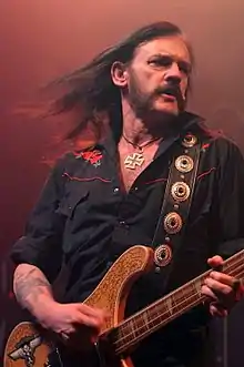 Lemmy onstage playing bass guitar