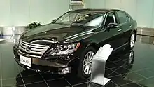 Angled forward view of sedan parked indoors.