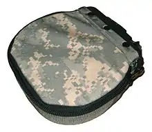 a canvas pouch in Universal Camouflage Pattern with a zipper and metal clip for mounting to the M249.