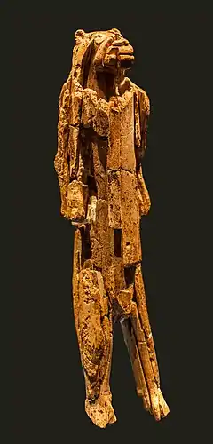 Tall figurine with a humanoid body and lion's head