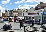 Market stalls and Elephant & Castle pub; behind the pub Green's End No. 18