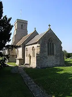 Stone building with square tower.