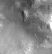 Lyot crater channel, as seen by CTX.  Water-carved channels have been spotted in Lyot crater; the curved line may be one.