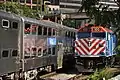 METX 100 leads a commuter train past another train out of Chicago Union Station in 2010