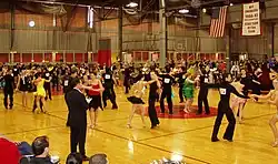 Image 11Intermediate level international-style Latin dancing at the 2006 MIT ballroom dance competition. A judge stands in the foreground. (from Latin American culture)