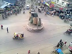 Madhupur Bus Stand, Tri-junction of three important roads of Bangladesh, The three roads goes to Tangail, Mymensingh and Jamalpur respectively. The pineapples signify the pineapple-growing area around Madhupur.