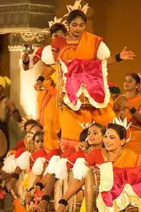 Colourfully-dressed women dancing