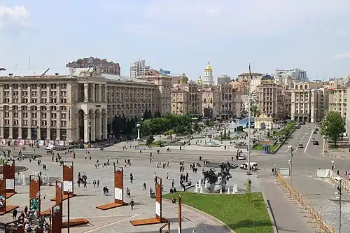 The fountain, near a corner of the square's intersection, in which the other monument stands