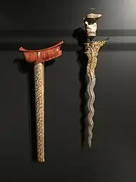 A Malay Keris, with its sheath on the left. This particular dagger was historically belonged to a Malay aristocrat from Sumatra.