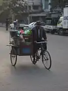 A mohinga trishaw peddler in Mandalay will stop for customers.