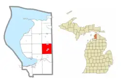 Location within Emmet County and the administered community of Brutus (1) and portion of the village of Pellston (pink)