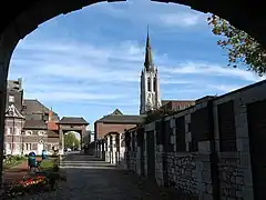 Southern part of the courtyard seen from the porch, with the Our Lady of Mercy church in the background, and the De Cartier metro station entrance on the right.