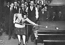 Margaret Lennan playing English billiards with an audience watching