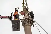 Sculptor Petr Váňa places the statue of the Virgin Mary on top of a replica of the Marian Column, June 4, 2020