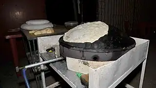 Markouk being prepared and cooked on a saj