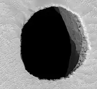 HiRISE image of Mars hole "Jeanne", about 150 meters (492 feet) across and at least 178 meters (584 feet) deep.